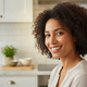 Headshot of a smiling woman in her 30s, representing a satisfied customer.